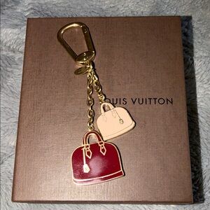 Louis Vuitton Gold and Red Alma Bag Charm Key Holder comes with box.